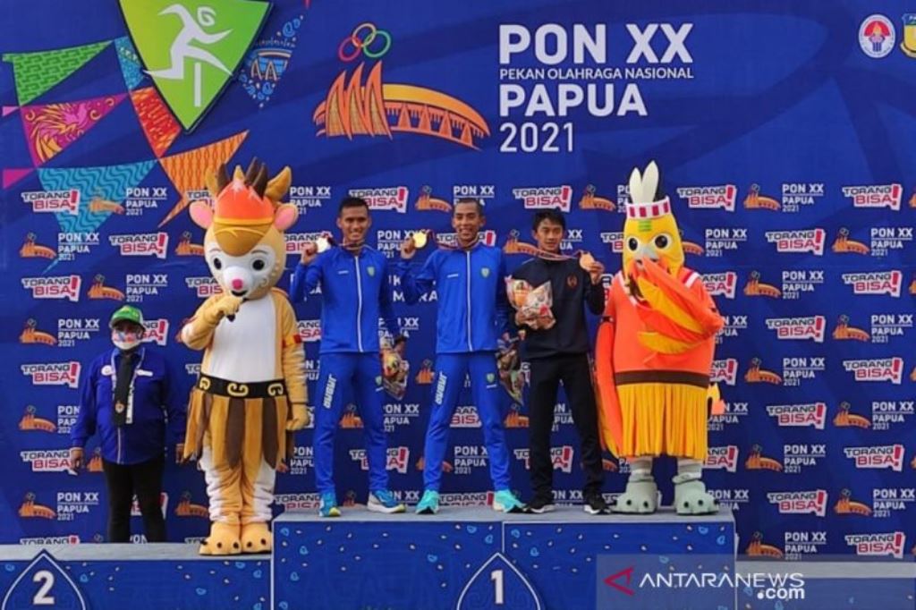 Pelari asal Jawa Barat Agus Prayogo (tiga kanan), pelari asal Jawa Barat Pandu Sukarya (empat kanan) dan pelari asal Bangka Belitung Robi Sianturi (dua kanan) berpose usai pengalungan medali nomor perlombaan 5.000 meter putra cabang olahraga atletik PON X